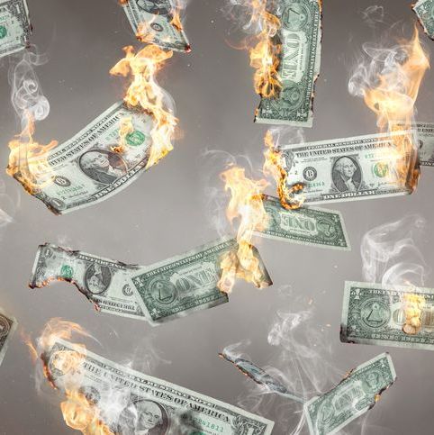 dollars on fire and falling in midair