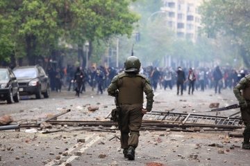 Solider walking in street towards people