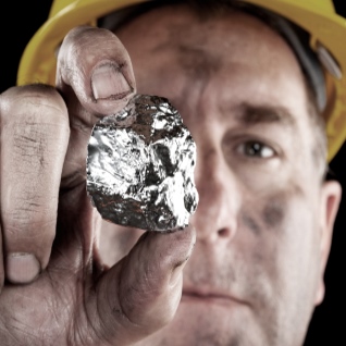 Miner holding silver nugget