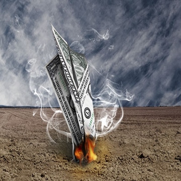 Paper airplane made of a dollar bill crashing to the ground on fire
